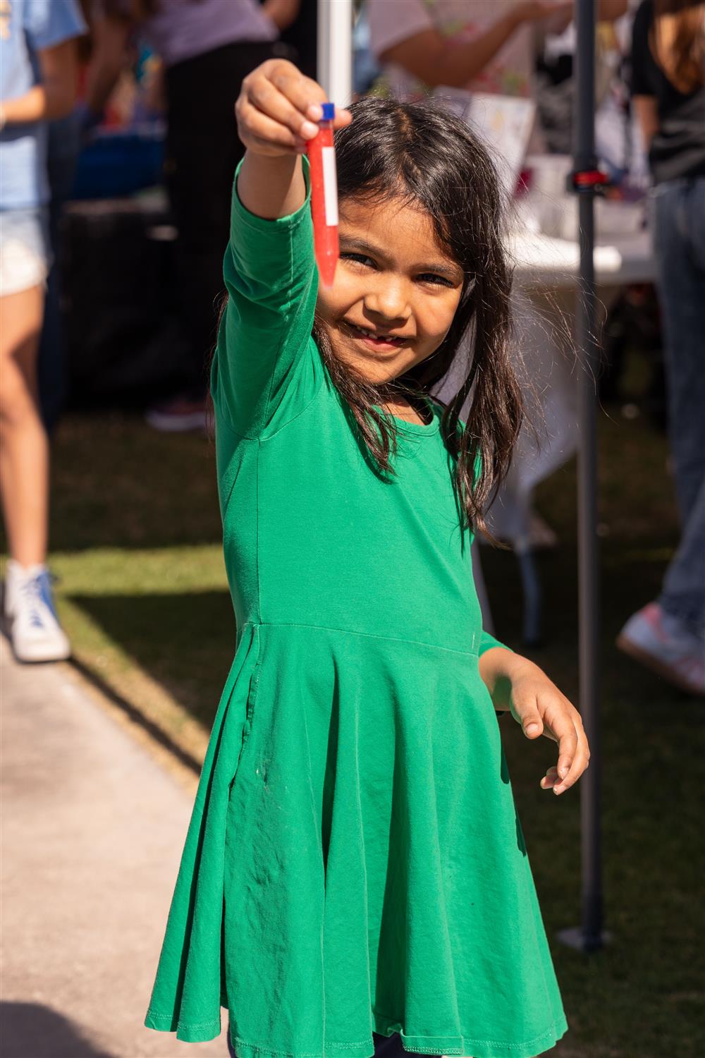 A child holds up a science experiment she worked on at Chandler Innovation Fair.